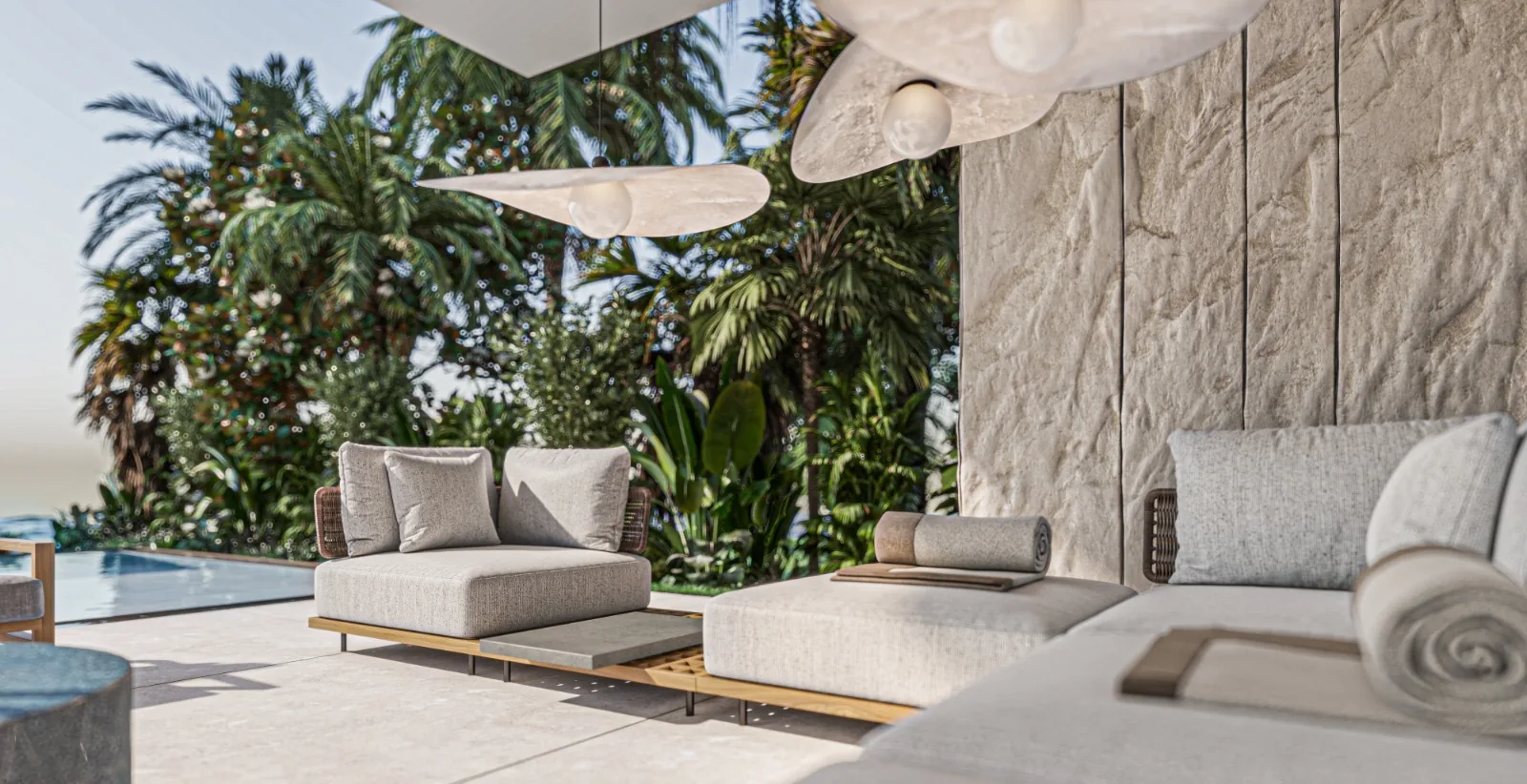 Modern patio with sectional seating, ceiling fans, tropical landscaping over pool.