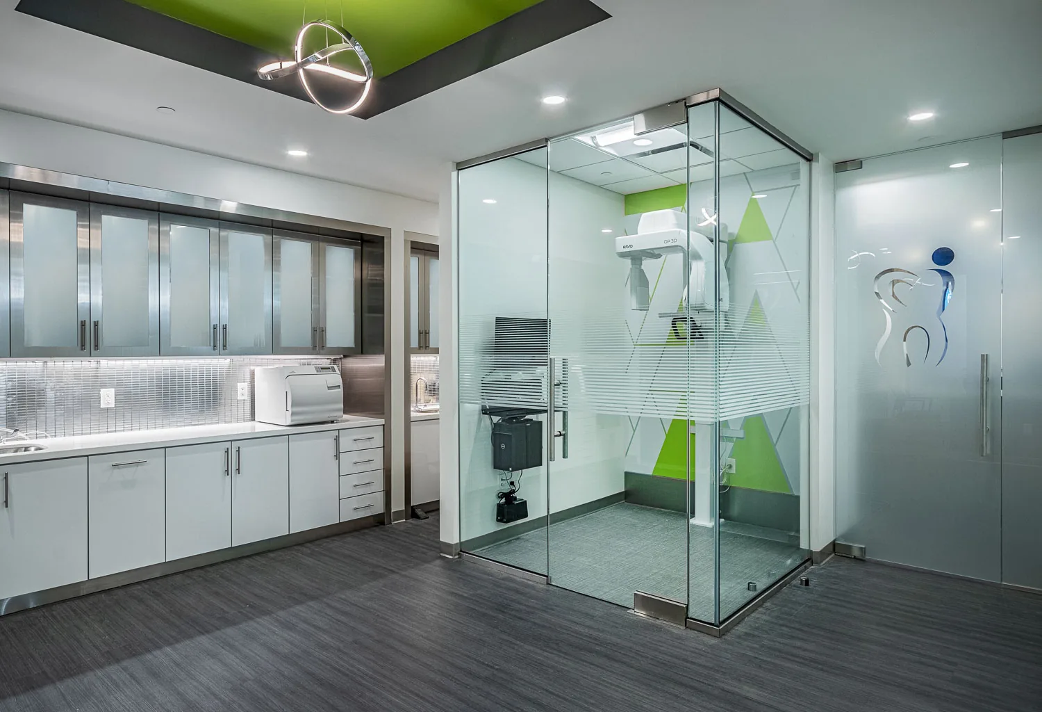 Office kitchen and fitness shower enclosure with white cabinetry and glass partitions.